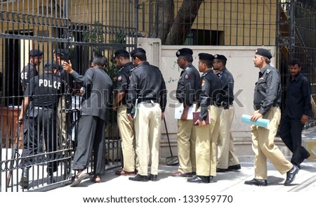 KARACHI, PAKISTAN - APR 04: Police officials are entering Supreme Court Registry building during hearing of the Karachi law and order case,  on April 04, 2013 in Karachi.