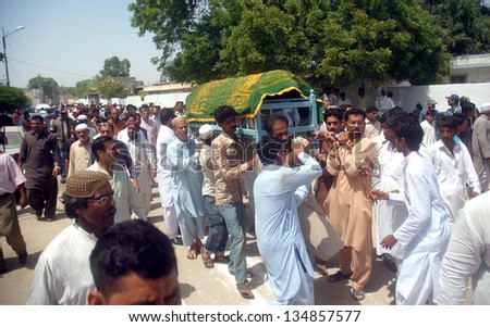 KARACHI, PAKISTAN - APR 12: People carry coffin of City warden Nasrullah Irfan, who was gunned down by unidentified persons at Fatimid Foundation in Soldier Bazaar area, on April 12, 2013 in Karachi.