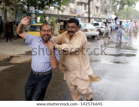 KARACHI, PAKISTAN - JUN 17: Police officials arresting a member of New Appointment  Teachers Action Committee during a protest demonstration near Sindh Assembly on June 17, 2013. in Karachi.