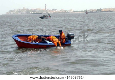 KARACHI, PAKISTAN - JUN 21: Rescue officials busy in search operation after a boat capsize in sea near Keamari port on June 21, 2013 in Karachi. The boat was carrying locals and tourists