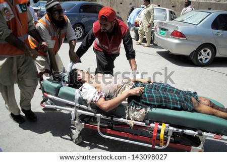 PESHAWAR, PAKISTAN - JUN 21: Victim of suicide bomb blast at Hussaini Madrassa  Chamkini area being shifted for treatment at Lady Reading hospital,  on June 21, 2013 in Peshawar.