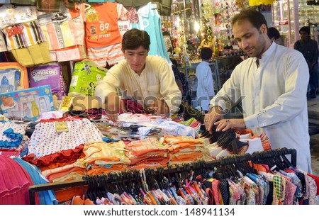 QUETTA, PAKISTAN - AUG 06: People busy in Eid shopping at market ahead of Eid- ul-Fitar during the Holy Month of Ramadan-ul-Mubarak  on August 06, 2013 in Quetta.