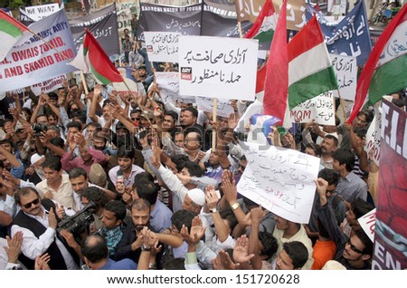 KARACHI, PAKISTAN - AUG 27: Members of Karachi Union of Journalists are protesting  against court notice that issued to a private television channel of Pakistan on August 27, 2013 in Karachi.