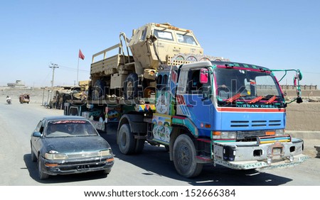 CHAMAN, PAKISTAN - SEP 03: Levis forces stand alert in the squad trucks which were carrying US military equipments coming from Kandahar crossing Pak-Afghan border on September 03, 2013 in Chaman.