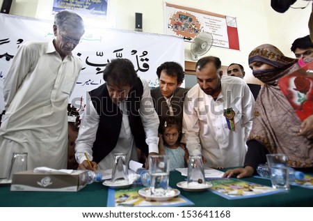 PESHAWAR, PAKISTAN - SEP 10: Chairman PTI signing a memorandum regarding educational reforms in government institutes, during a ceremony at Cant Number 1 School on September 10, 2013 in Peshawar.
