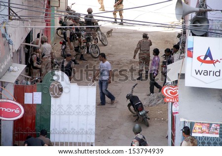 KARACHI, PAKISTAN - SEP 11: Security cordon off residential complex during  targeted serch operation against criminal and arrested a numbers of suspected persons on September 11, 2013 in Karachi.