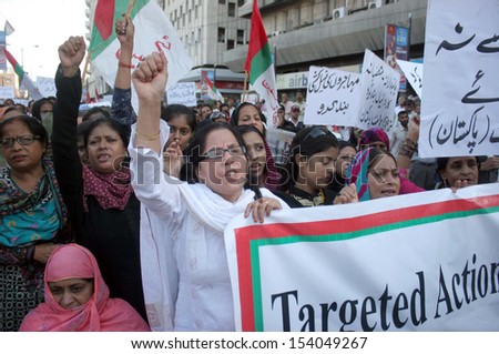 KARACHI, PAKISTAN - SEP 13: Supporters of MQM are protesting against arresting of their party workers and leaders in target search operation by security forces, on September 13, 2013 in Karachi.