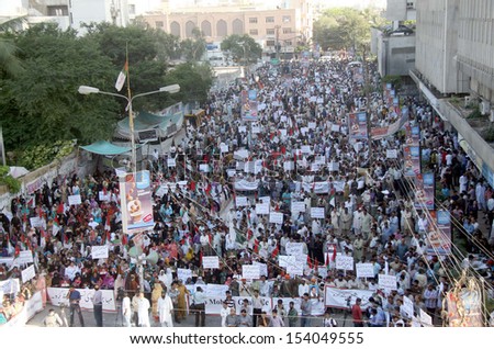 KARACHI, PAKISTAN - SEP 13: Supporters of MQM are protesting against arresting of their party workers and leaders in target search operation by security forces, on September 13, 2013 in Karachi.