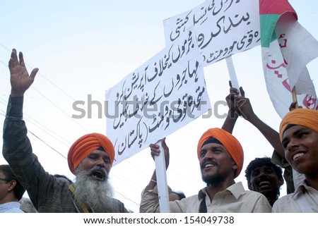 KARACHI, PAKISTAN - SEP 13: Supporters of MQM are protesting against arresting of their party workers and leaders in target search operation by security forces, on September 13, 2013 In Karachi.