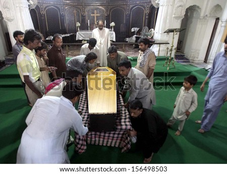 PESHAWAR, PAKISTAN - OCT 01: Christian people offering funeral ritual of thirteen years old Samran who was the victim of Kohati Gate Church bomb blast died on on October 01, 2013 in Peshawar.