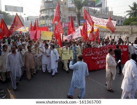 KARACHI, PAKISTAN - NOV 04: Members of Site Laborers Action Committee are protesting against grabbing of laborers flats by land mafia during a demonstration on November 04, 2013 in Karachi.