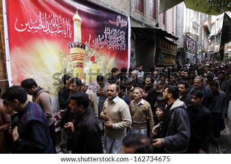 PESHAWAR, PAKISTAN - NOV 13: Shiite Muslims participate in religious procession in  account of 8th Muharram-ul-Haram, pass through at a road on November 13, 2013 in Peshawar.
