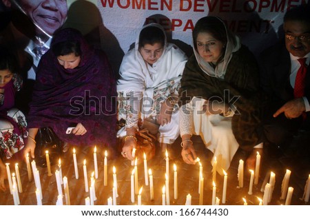 KARACHI, PAKISTAN - DEC 10: Sindh Assembly members enlightening candles in memory of Nelson Mandela who died on Thursday at age 95 during a demonstration on December 10, 2013 in Karachi.