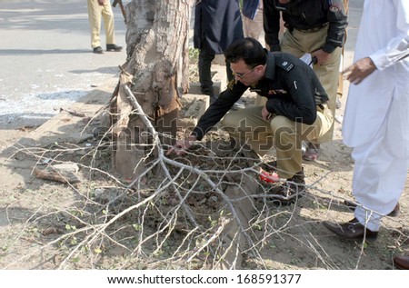 KARACHI, PAKISTAN - DEC 24: Security officials inspecting site after dual bomb blast in  Orangi Town area occurred near an Imam Bargah, on December 24, 2013 in Karachi.