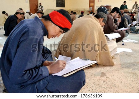 CHAMAN, PAKISTAN - FEB 25: Intermediate students solve examination papers during  Annual Examination 2014 at an examination hall, on February 25, 2014 in Chaman.