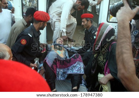 KARACHI, PAKISTAN - FEB 26: Police arresting teachers who were protesting against  corruption in Education Department of Sindh during a demonstrationon February 26, 2014 in Karachi.