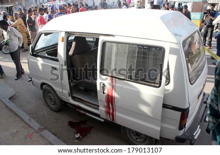 KARACHI, PAKISTAN - FEB 27: People gather near vehicle of seminary teacher, named Javed who was assassinated by unidentified gunmen in AL-Noor Society of F.B Area on February 27, 2014 in Karachi.