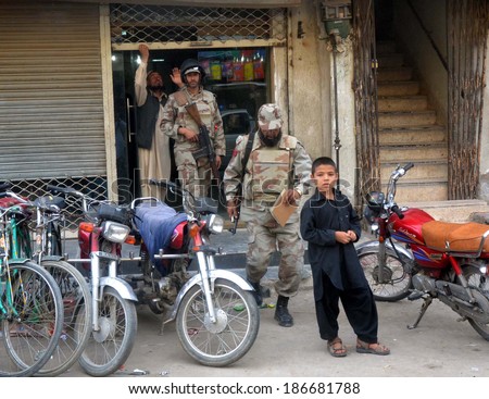 QUETTA, PAKISTAN - APR 11: Security official are at venue after robbery in a private bank located at Masjid Road of on April 11, 2014 in Quetta. Robbers looted rupees two billion in robbery.