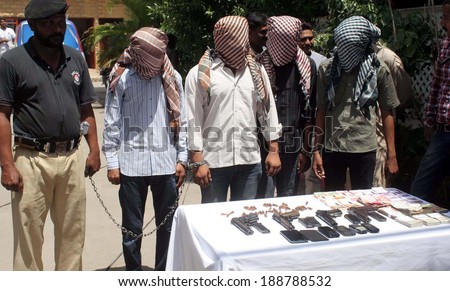 KARACHI, PAKISTAN - APR 23: Robbers involved in robbery a private bank of Korangi  arrested in intelligence based raid in Landhi area are being exposing to media persons on April 23, 2014 in Karachi.
