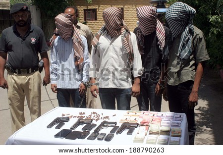 KARACHI, PAKISTAN - APR 23: Robbers involved in robbery a private bank of Korangi  arrested in intelligence based raid in Landhi area are being exposing to media persons  on April 23, 2014 in Karachi.