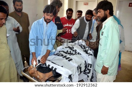 QUETTA, PAKISTAN - MAY 15: Medical staffs busy in examine dead body of man who killed by unidentified gunmen at Mekangi Road, on May 15, 2014 in Quetta.