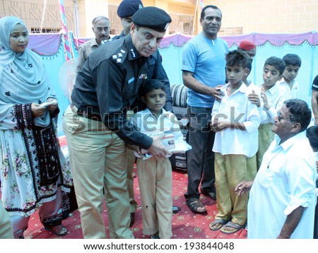 KARACHI, PAKISTAN - MAY 20: IG Police Chief Karachi distributes School Course and Uniform among needy student of Government Secondary School during Distribution Ceremony on May 20, 2014 in Karachi.