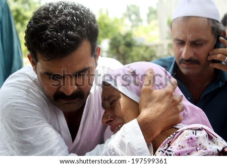 KARACHI, PAKISTAN - JUN 09: Relatives of missing Airport Security Force personnel wait for the updates after suspected militants attacked the Jinnah International Airport on June 09, 2014 in Karachi.