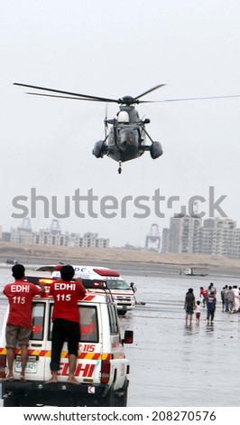 KARACHI, PAKISTAN - JUL 31: Happiness of Eid drown into sadness, numbers of people drown into sea as the rescue volunteers of Pak Navy and Edhi Foundation are searching on July 31, 2014 in Karachi.