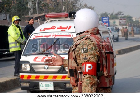 PESHAWAR, PAKISTAN - DEC 16: Security personnel cordon off venue and conducted an operation against militants after militants attacked an Army Public School on December 16, 2014 in Peshawar.