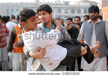 PESHAWAR, PAKISTAN - DEC 16: Victims of militants attacked an Army Public School  situated on Warsak Road, being shifted for treatment at local hospital on December 16, 2014 in Peshawar.