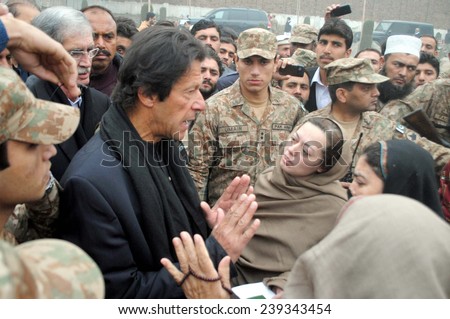 PESHAWAR, PAKISTAN - DEC 22: (PTI) Chairman, Imran Khan talking with parents of student who killed in Taliban attack on an Army Public School on past Tuesday, on December 22, 2014 in Peshawar.