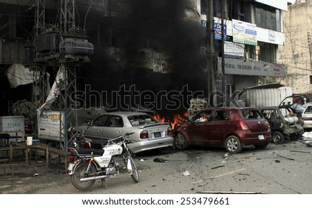 LAHORE, PAKISTAN - FEB 17: Column of black smoke rising above buildings from burning cars after suicidal bombing near Police Lines in Qila Gujar Singh area on February 17, 2015 in Lahore.