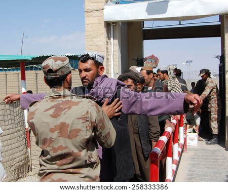 CHAMAN, PAKISTAN - MAR 06: Pakistan security forces staffs searching Afghan Nationals entering into Pakistan via Chaman Boarder, on March 06, 2015 in Chaman.