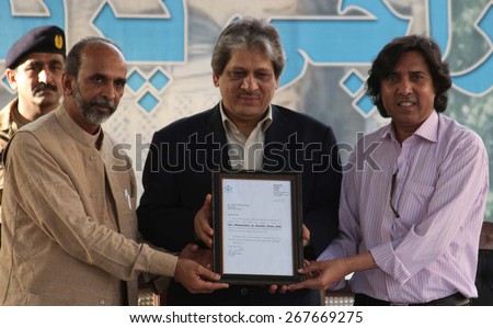 KARACHI, PAKISTAN - APR 08: Sindh Governor, receiving life time membership of Karachi press club from office bearers of club, during Meet the Press Conference on April 08, 2015 in Karachi.