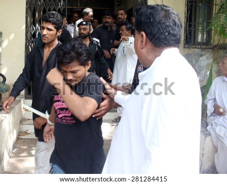 KARACHI, PAKISTAN - MAY 25: Arrested guards of Former Home Minister Sindh, Zulfiqar Mirza are being escorted by police while appearing them to Anti Terrorism Court on May 25, 2015 in Karachi.