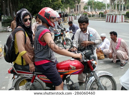 LAHORE, PAKISTAN - JUN 10: Disable blinds persons block Mall road as they are protesting against unemployment during demonstration outside Punjab Assembly building on June 10, 2015 in Lahore.
