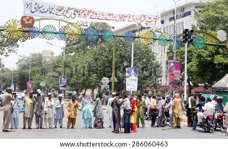 LAHORE, PAKISTAN - JUN 10: Disable blinds persons block Mall road as they are protesting against unemployment during demonstration outside Punjab Assembly building on June 10, 2015 in Lahore.