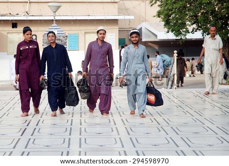 KARACHI, PAKISTAN - JUL 08: Faithful Muslims arrive for Itikaf at a local mosque, Itikaf is a pious Islamic practice consisting of a period of retreat in a mosque on July 08, 2015 in Karachi.