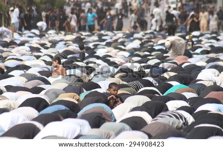 KARACHI, PAKISTAN - JUL 09: Shiite Muslims offering Zohrain prayer during procession on the occasion of Day of Martyrdom of Hazrat Ali (A.S), at M.A Jinnah Road on July 09, 2015 in Karachi.