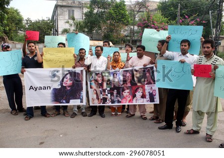 LAHORE, PAKISTAN - JUL 13: Members of Civil Society chant slogans for releasing of Super Model Ayyan Ali, who is currently under custody in a money-laundering case, on July 13, 2015 in Lahore.