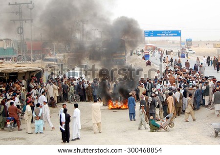CHAMAN, PAKISTAN - JUL 27: Members of M.A.T and Tribal Elders burn tyres and block road as they are protesting against burn tyres handedness of Chaman Custom officials on July 27, 2015 in Chaman.