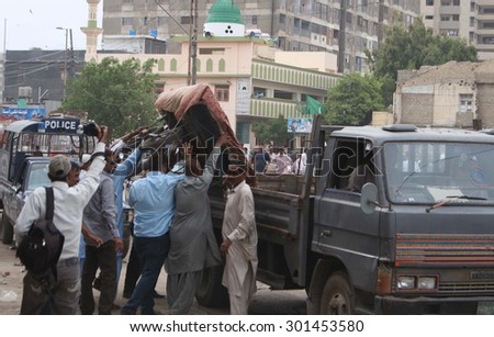 KARACHI, PAKISTAN - JUL 30: An anti encroachment operation is being carried out in Saddar area by KMC staff seized pushcarts of vendors, on July 30, 2015 in Karachi.