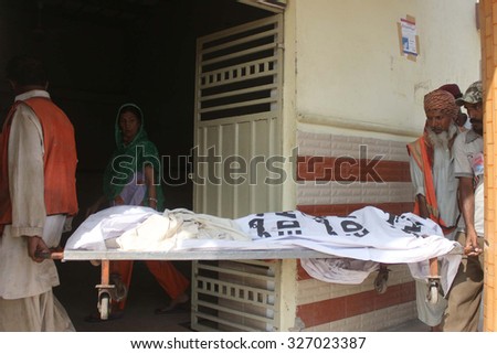 KARACHI, PAKISTAN - OCT 13: Recovered dead bodies after a landslide hit huts in Gulistan Johar Block-1 area of Karachi being shifting to Edhi Morgue on October 13, 2015 in Karachi.