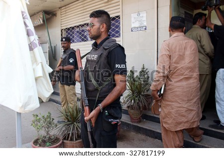 KARACHI, PAKISTAN - OCT 15: Security staffs cordon off bank after a robbery attempt, in Landhi area on October 15, 2015 in Karachi. A robber killed during exchange of firing with bank guards.