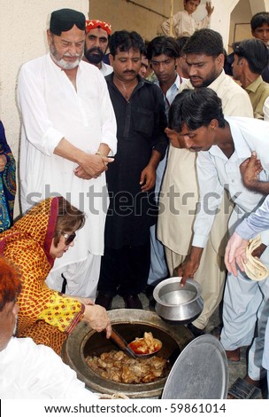 KARACHI, PAKISTAN, AUG 26: Zeenat Bhutto distributes food among flood affected people at flood relief camp established at a government school at Bhatiabad on August 26, 2010 in Karachi, Pakistan