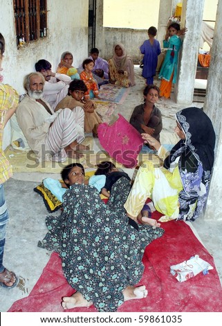 KARACHI, PAKISTAN, AUG 26: Flood affected people rest on floor at flood relief camp established at a government school at Bhatiabad on August 26, 2010 in Karachi, Pakistan