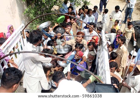 KARACHI, PAKISTAN, AUG 26: Food being distributed among flood affected people at flood relief camp established at a government school at Bhatiabad on August 26, 2010 in Karachi, Pakistan