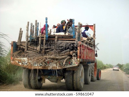 TANDO MOHAMMAD KHAN, PAKISTAN, AUG 26: People sit with their household  on a vehicle as they are moving towards safe place on August 26, 2010 in Tando Mohammad Kahn, Pakistan