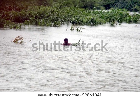 TANDO MOHAMMAD KHAN, PAKISTAN, AUG 26: Resident of Molchand move  towards safe place through flood waters as his house and agriculture land were flooded on August 26, 2010 in Tando Mohammad Kahn, Pakistan