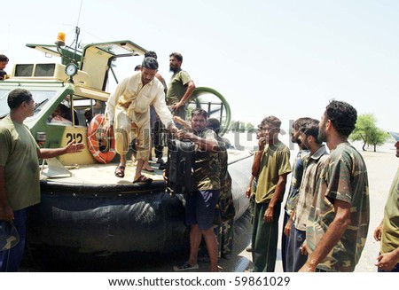 KARACHI, PAKISTAN, AUG 26: Flood affected people being shifted by a Navy (PN) rescue team during rescue operation at a flood affected area on August 26, 2010 in Karachi, Pakistan